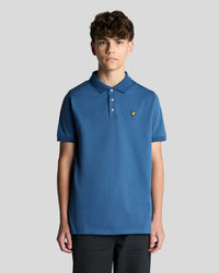 Man wears Cotton Polo Shirt in Dark Cornflower