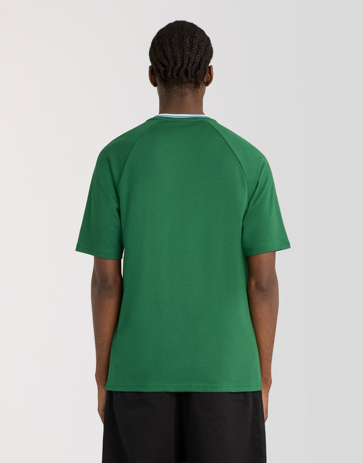 Man wears Tipped Track T-Shirt in Clover Green