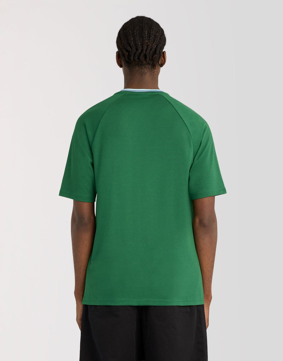 Man wears Tipped Track T-Shirt in Clover Green
