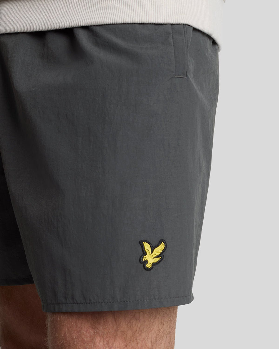 Man wears Plain Swim Shorts in Gunmetal