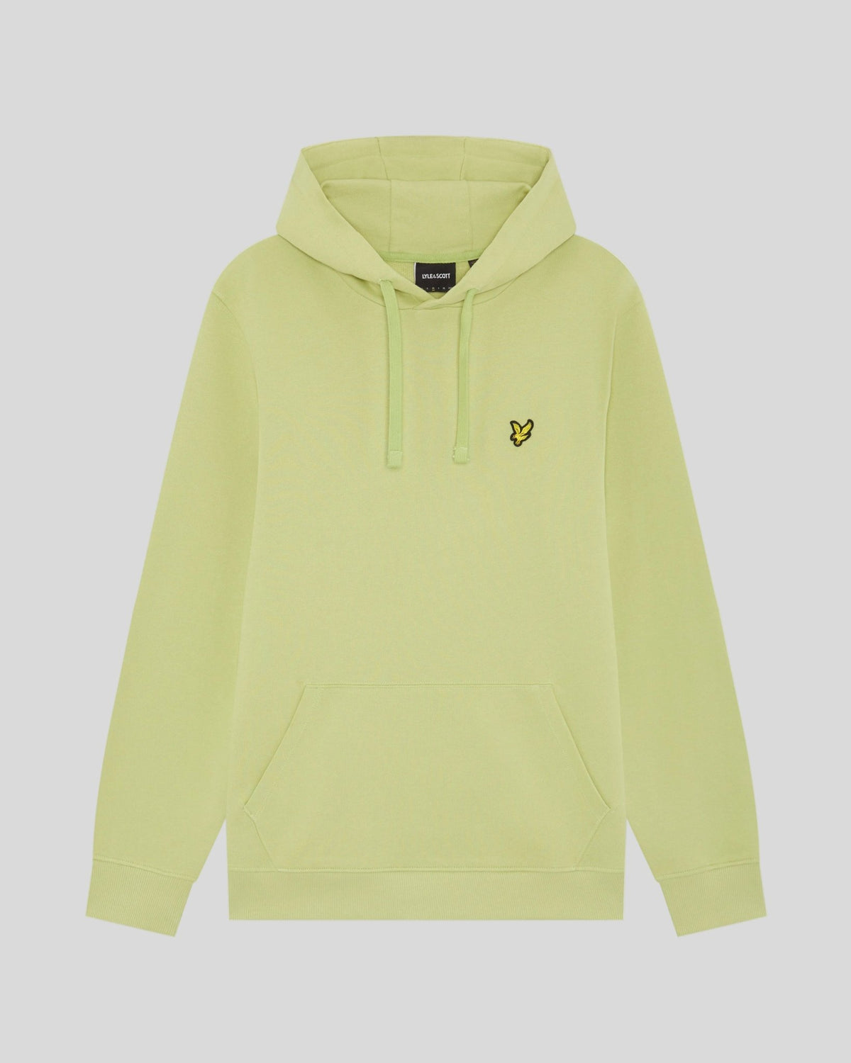 Un homme porte un sweat à capuche Loopback en coton, couleur « Green Grass »
