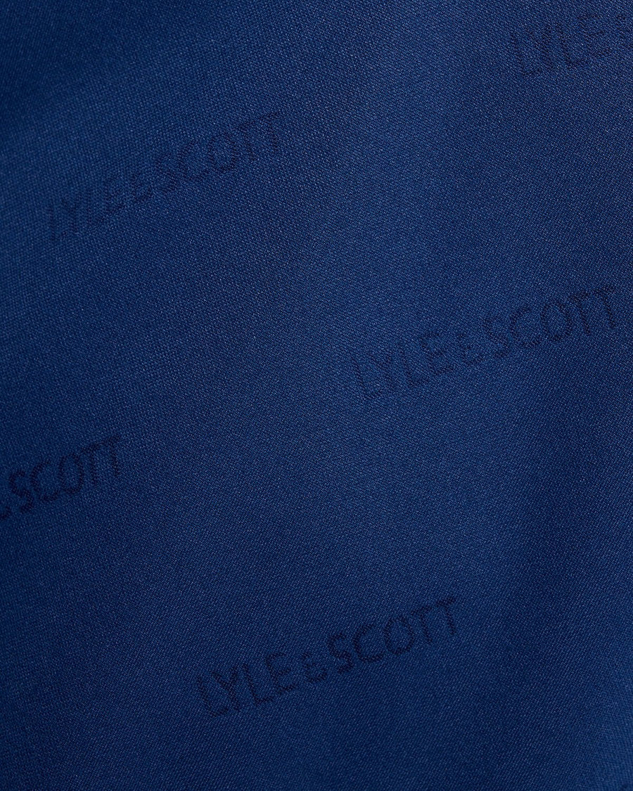 Pantalones cortos de fútbol con el logotipo en relieve, en color azul marino y rosa peonía