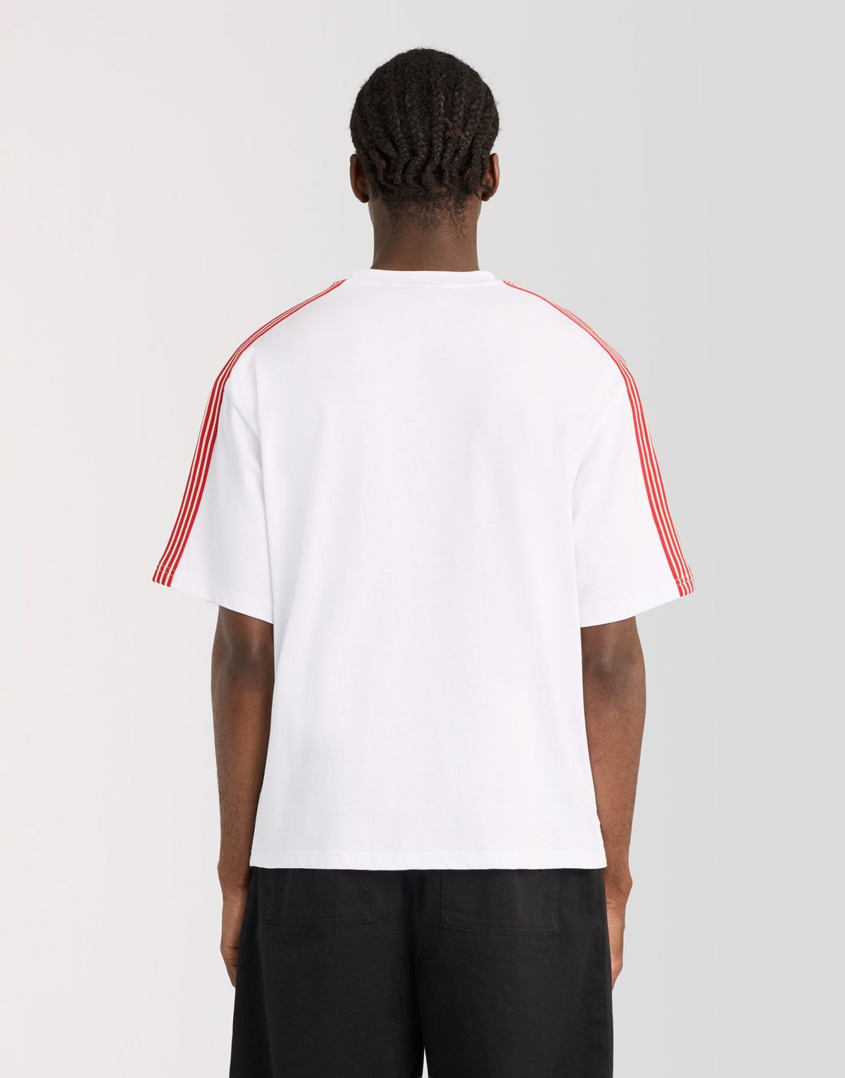 Man wears Stripe Taped Cotton T-Shirt in White