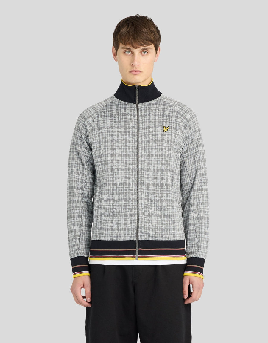 Man wears Hawick Cotton Check Track Jacket in Mid Grey Marl
