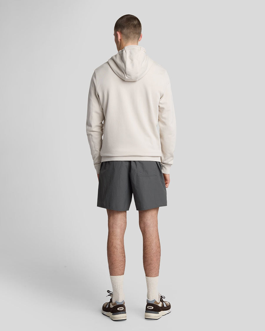 Man wears Plain Swim Shorts in Gunmetal