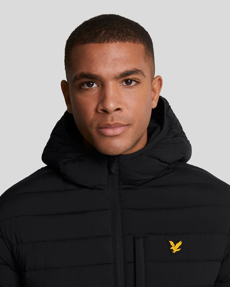 Man wears Sports Water Resistant Puffer Jacket in Jet Black