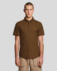 Man wears Short Sleeve Oxford Shirt in Walnut