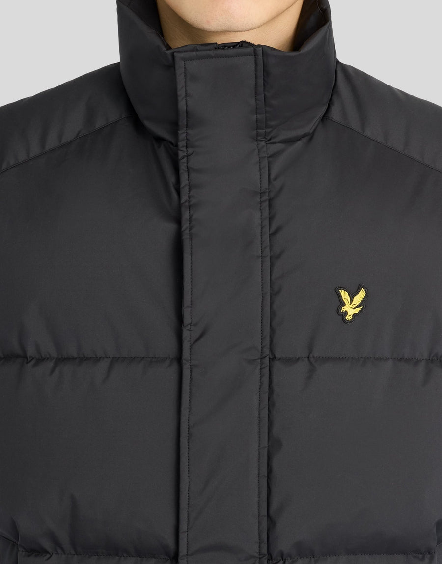Man wears Funnel Neck Puffer Gilet in Jet Black