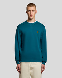 Man wears Cotton Crew Neck Sweatshirt in Lagoon
