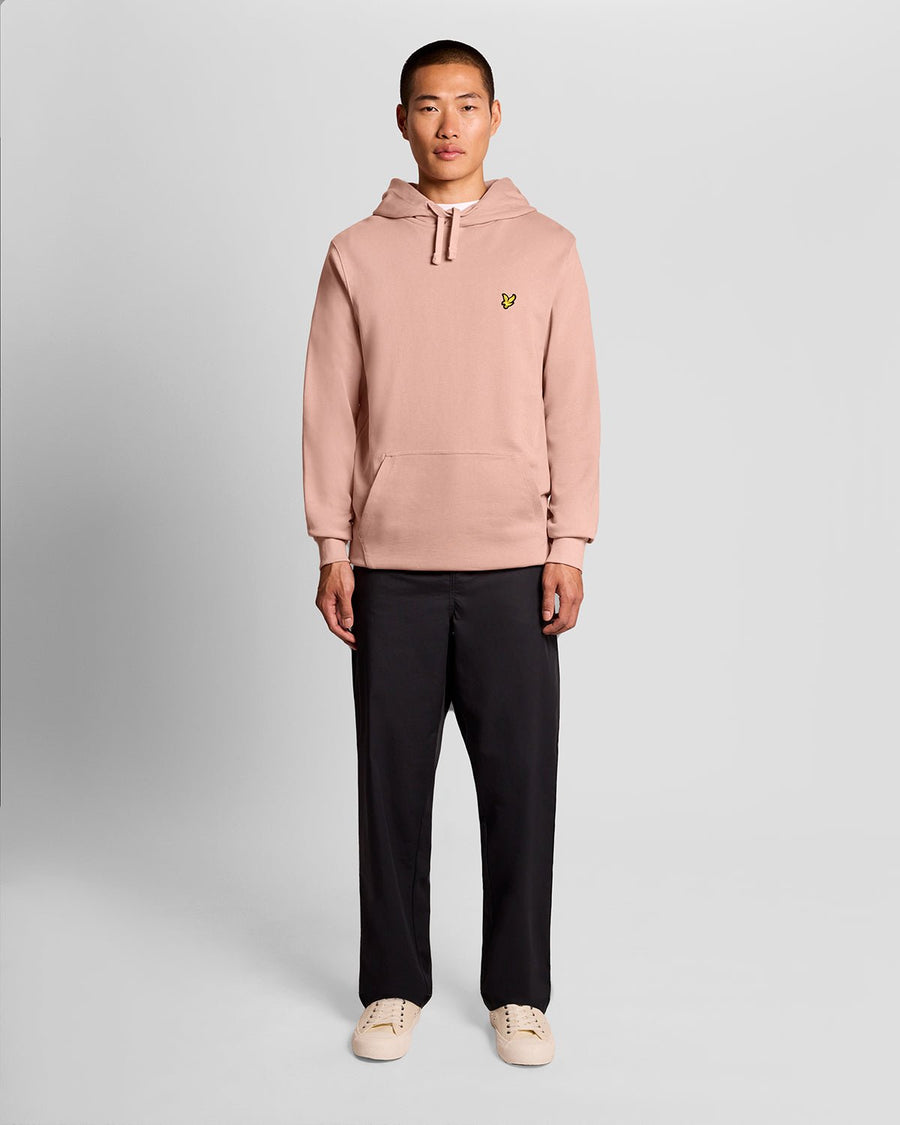 L'uomo indossa una felpa con cappuccio Loopback in cotone color rosa pompelmo