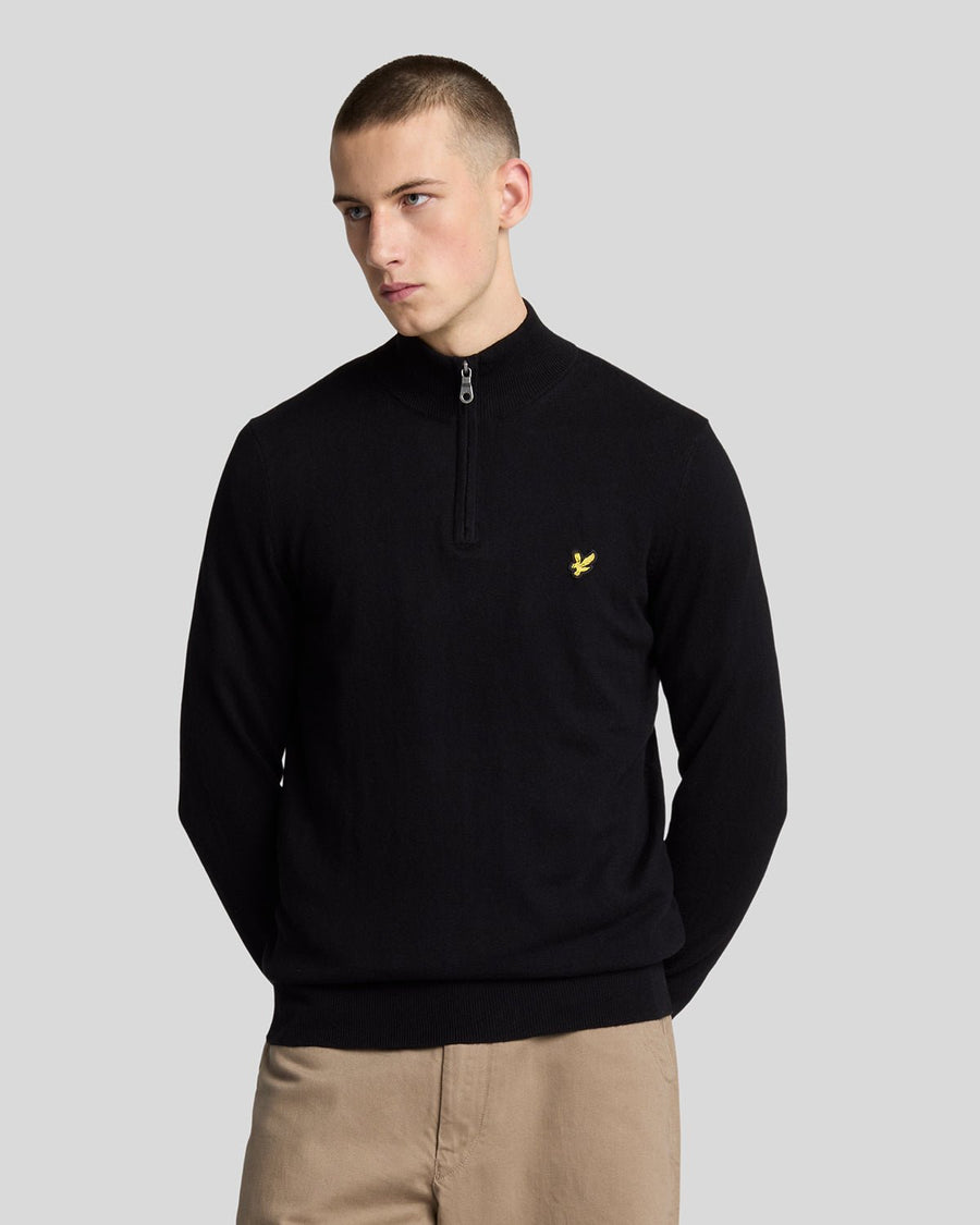 Man wears Cotton Merino 1/4 Zip Jumper in Jet Black