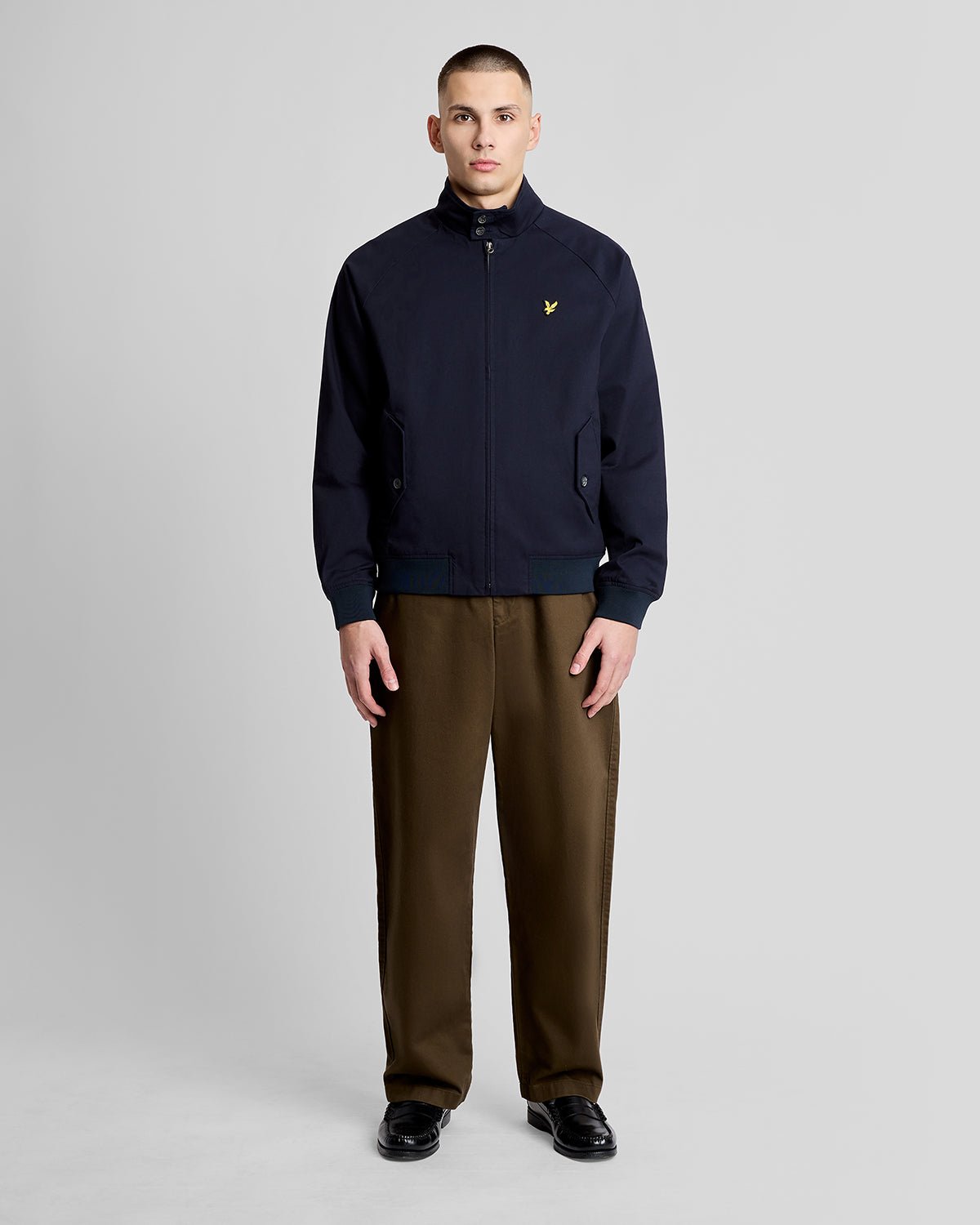 Man wears Cotton Harrington Jacket in Dark Navy