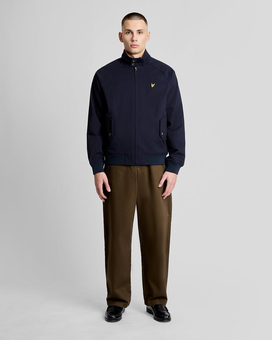 Man wears Cotton Harrington Jacket in Dark Navy