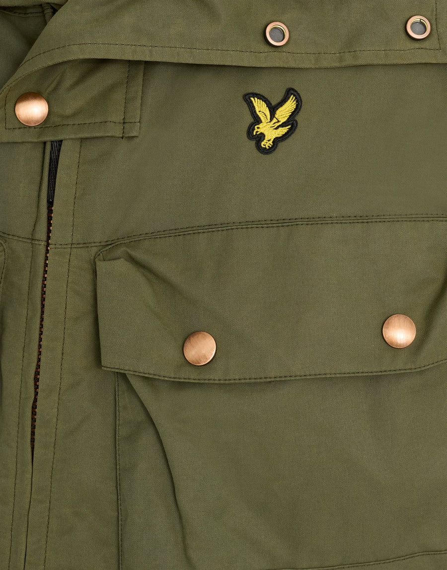 Man wears Waxed Guard Parka in True Olive