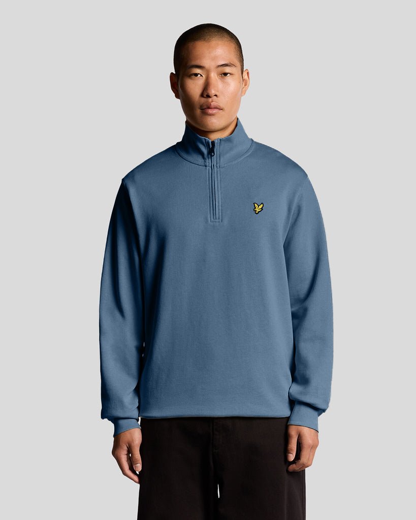 Man wears Everyday 1/4 Zip Cotton Sweatshirt in Ocean Sky