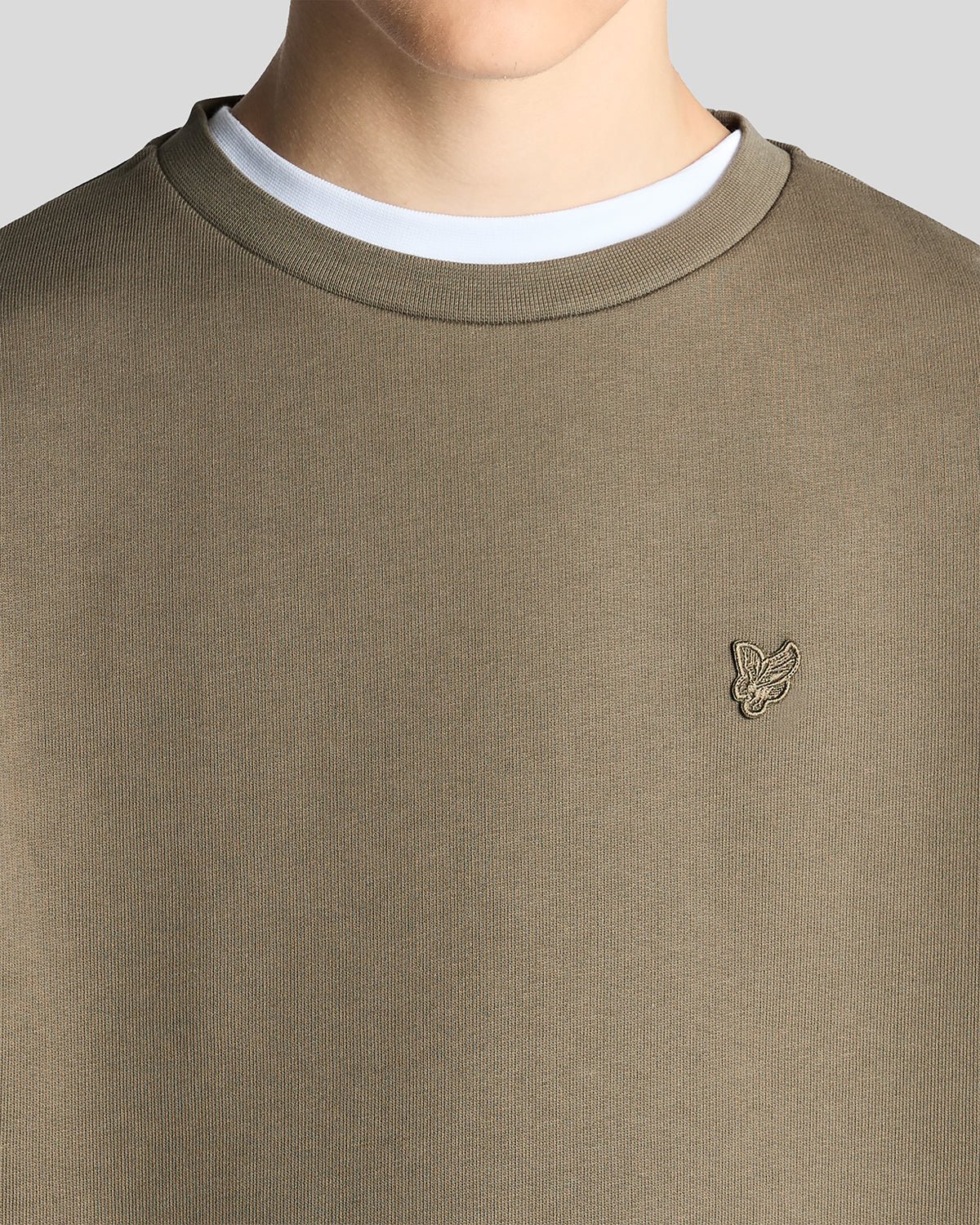 Un homme porte un sweat-shirt en coton épais de couleur kaki cendré