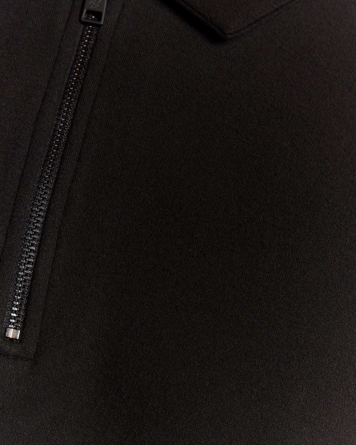 Man wears Interlock Zipped Polo Shirt in Jet Black
