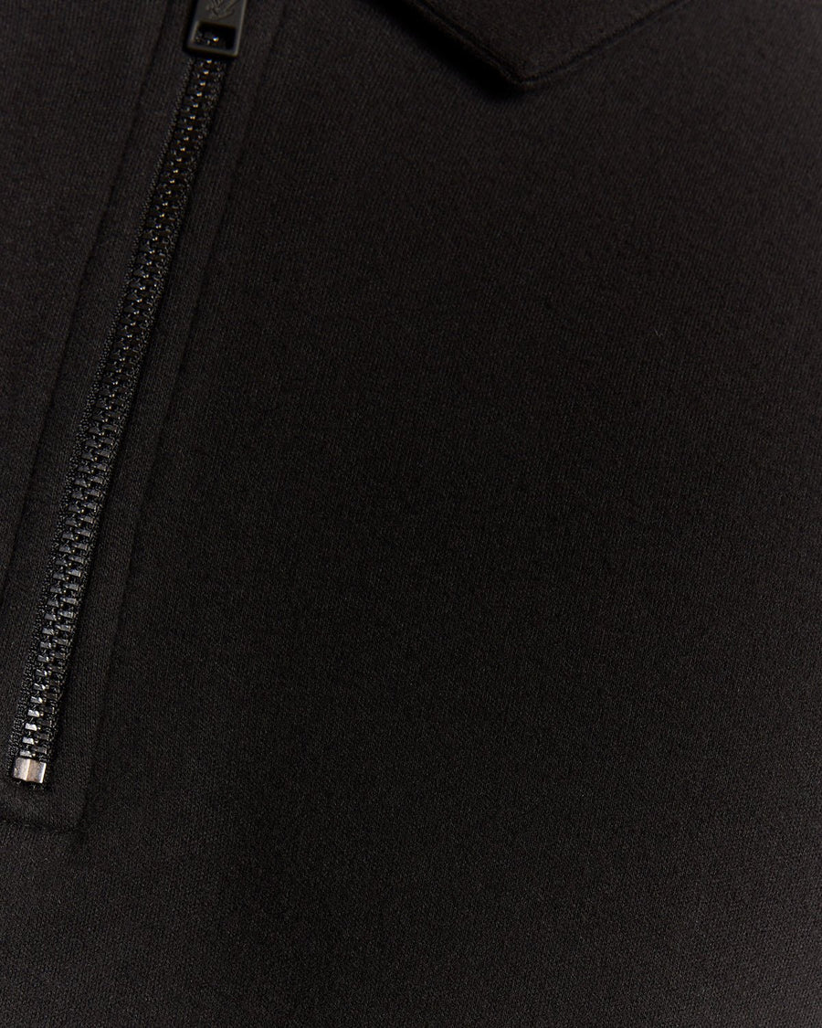 Man wears Interlock Zipped Polo Shirt in Jet Black