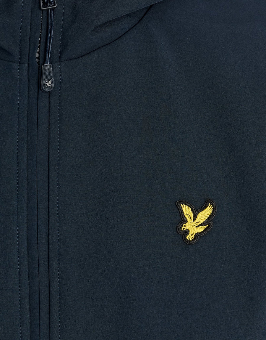 Man wears Sports Mesh-Back Softshell Jacket in Dark Navy
