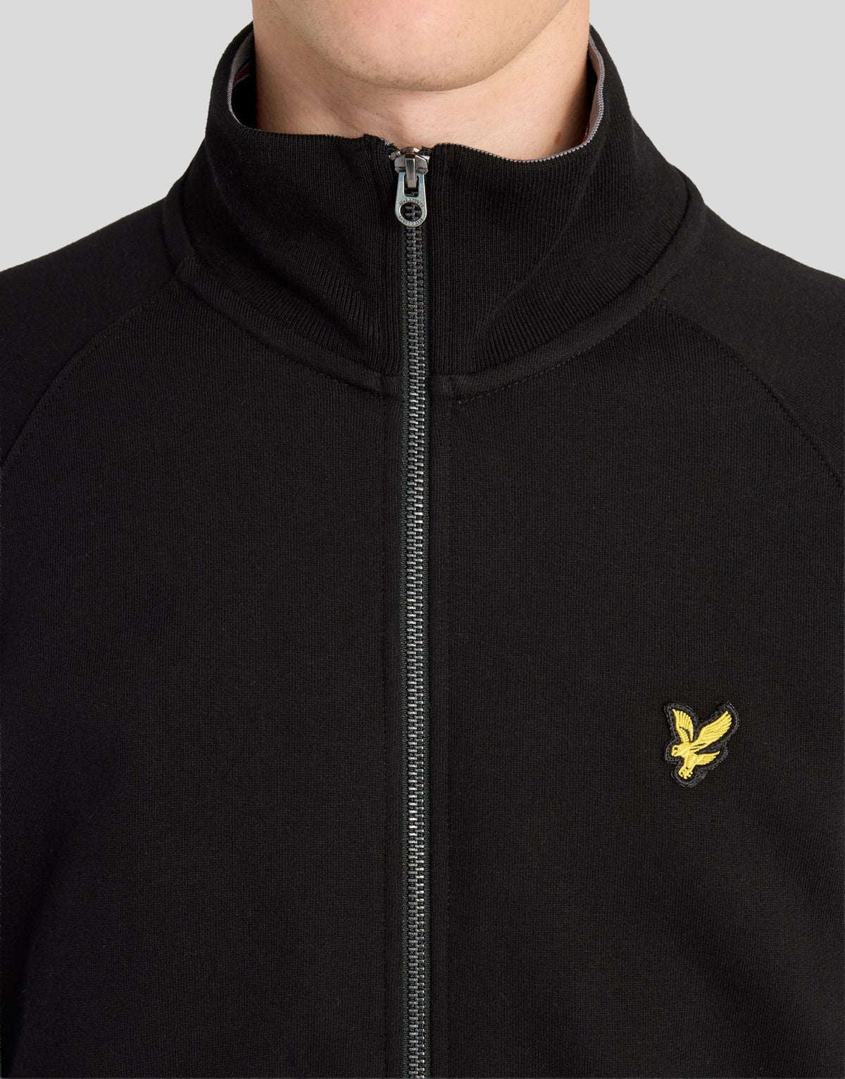 Man wears Cotton Tipped Track Jacket in Jet Black
