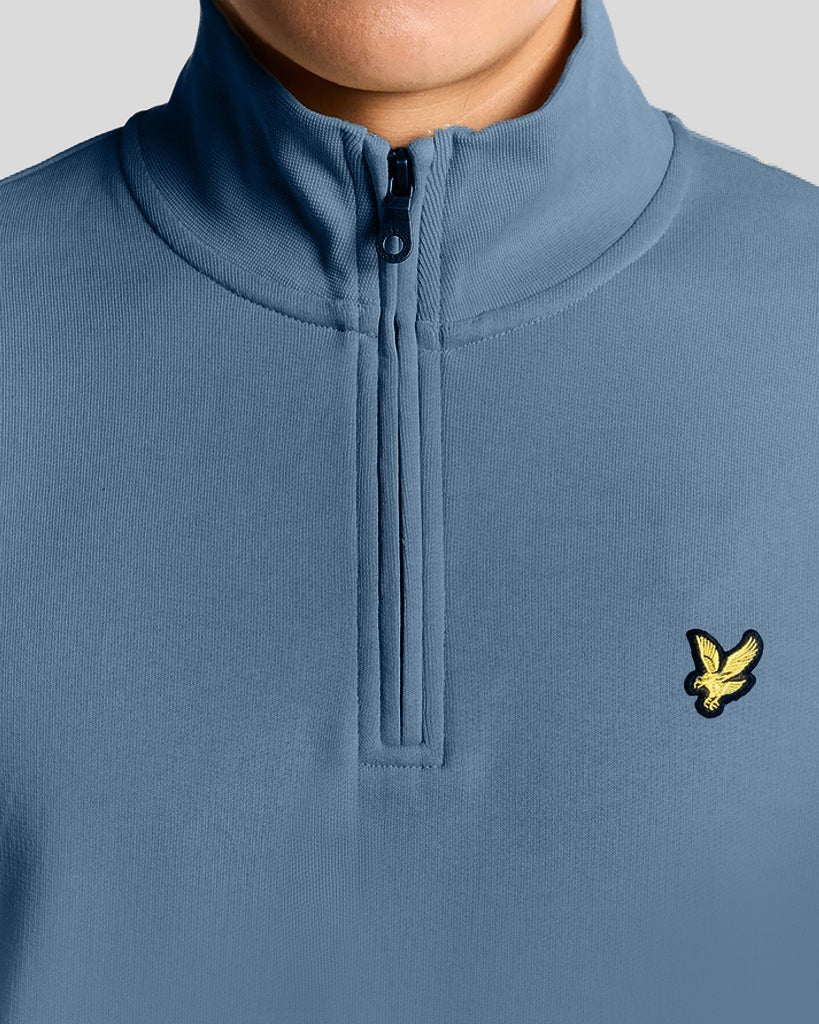 Man wears Everyday 1/4 Zip Cotton Sweatshirt in Ocean Sky