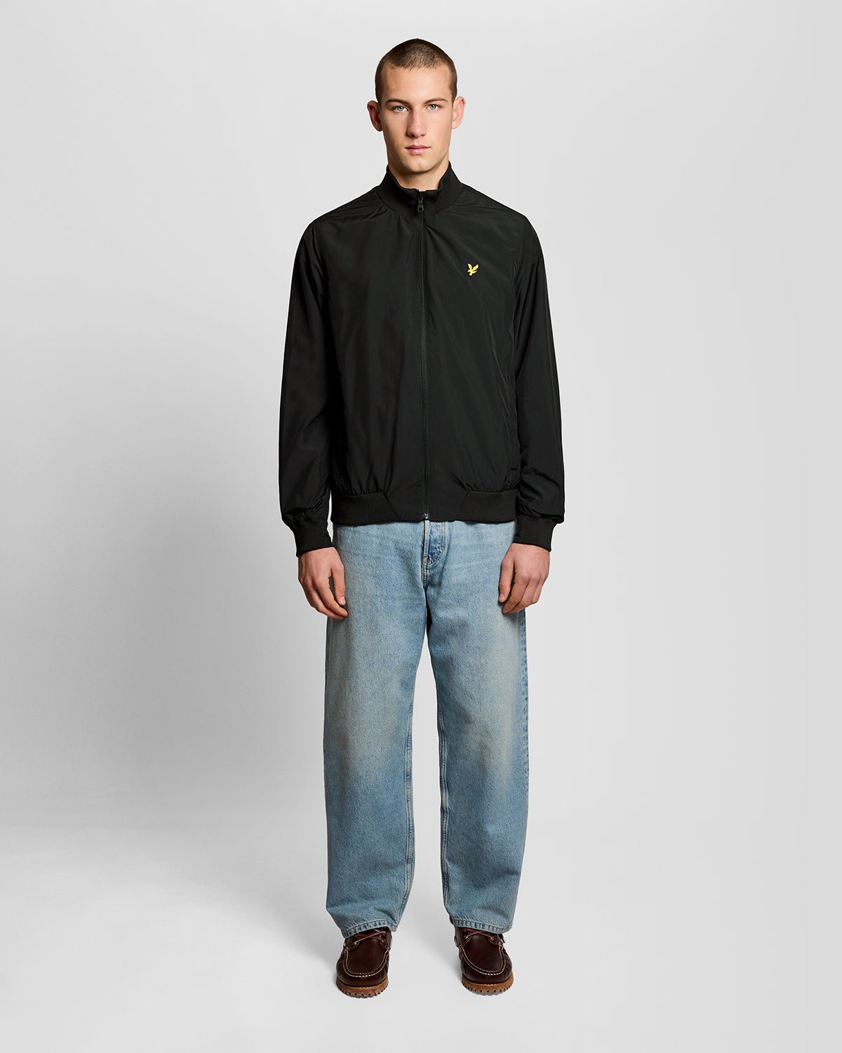 Un homme porte une veste à col cheminée de couleur noir jais