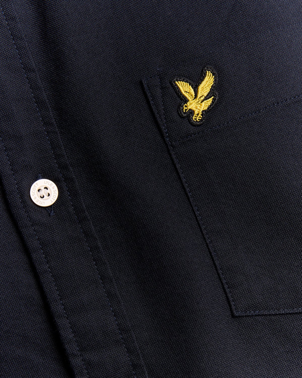 Un homme porte une chemise Oxford en coton à boutons, bleu marine foncé