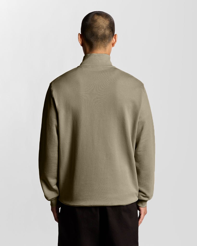 Man wears Everyday 1/4 Zip Cotton Sweatshirt in Woolwich