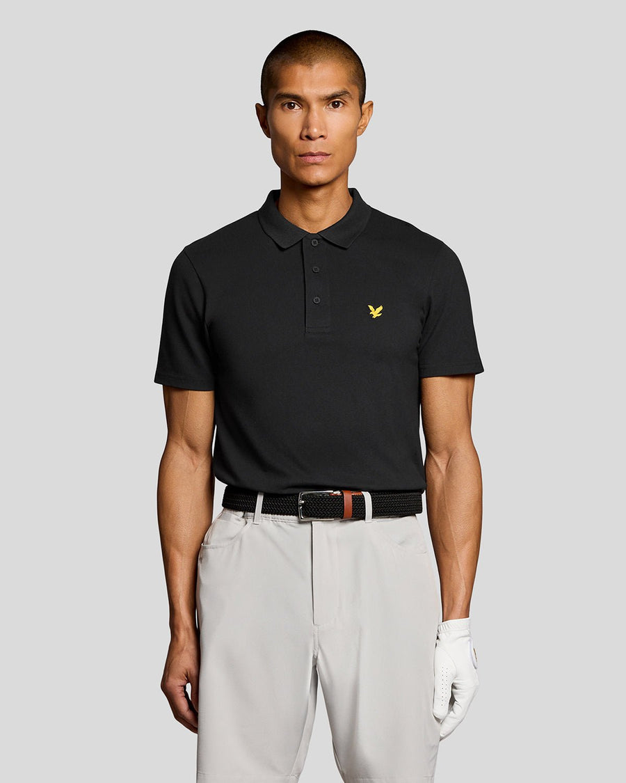 Un homme porte un polo technique noir de jais