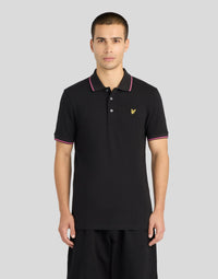 Man wears Tipped Polo Shirt in Jet black/ Pink flare