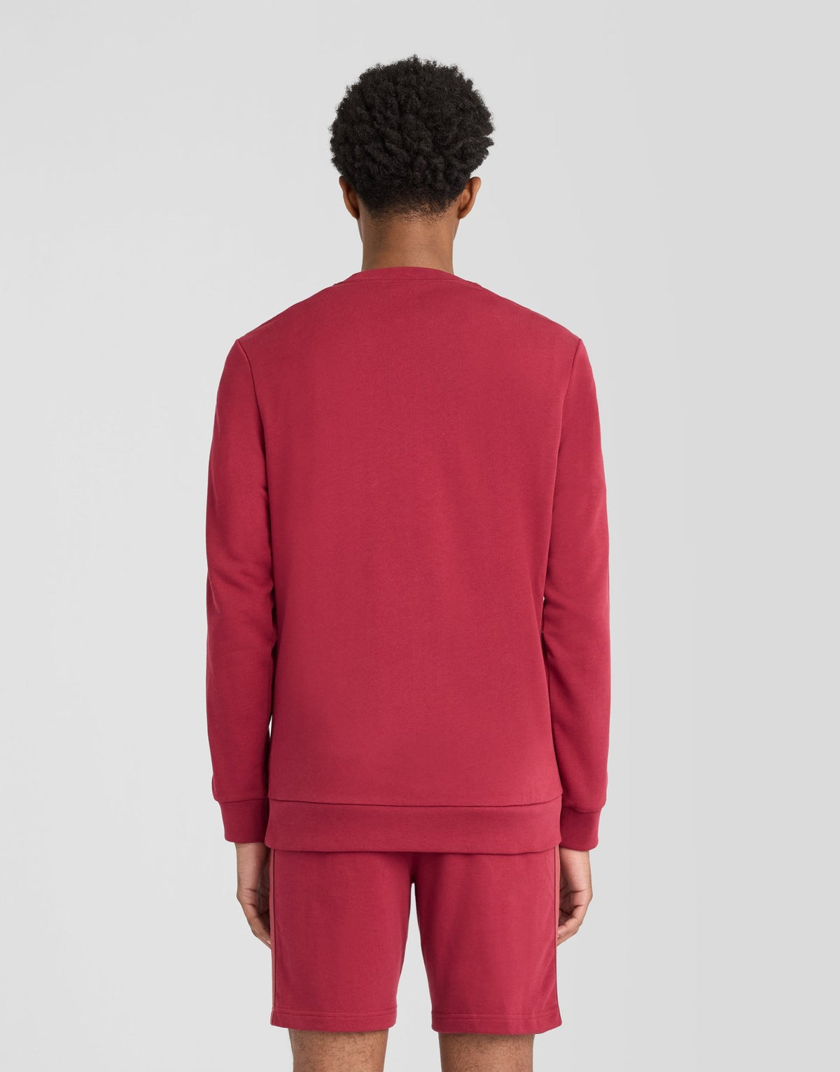 Man wears Sports Tape Crew Neck Sweatshirt in Plum