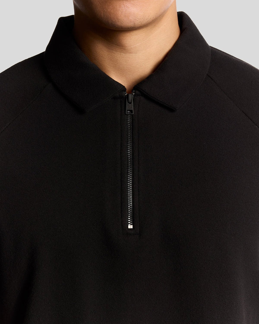 Man wears Interlock Zipped Polo Shirt in Jet Black