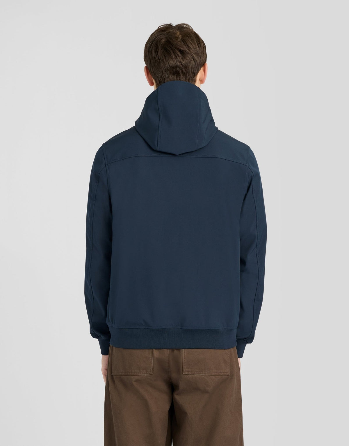 Man wears Sports Mesh-Back Softshell Jacket in Dark Navy