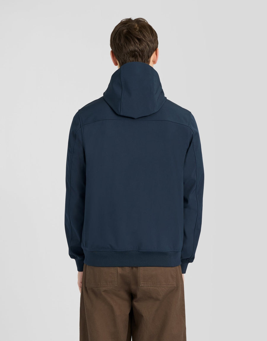 Man wears Sports Mesh-Back Softshell Jacket in Dark Navy