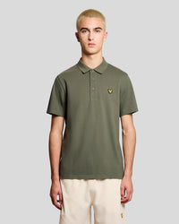 Man wears Sports Polo Shirt in Cactus Green