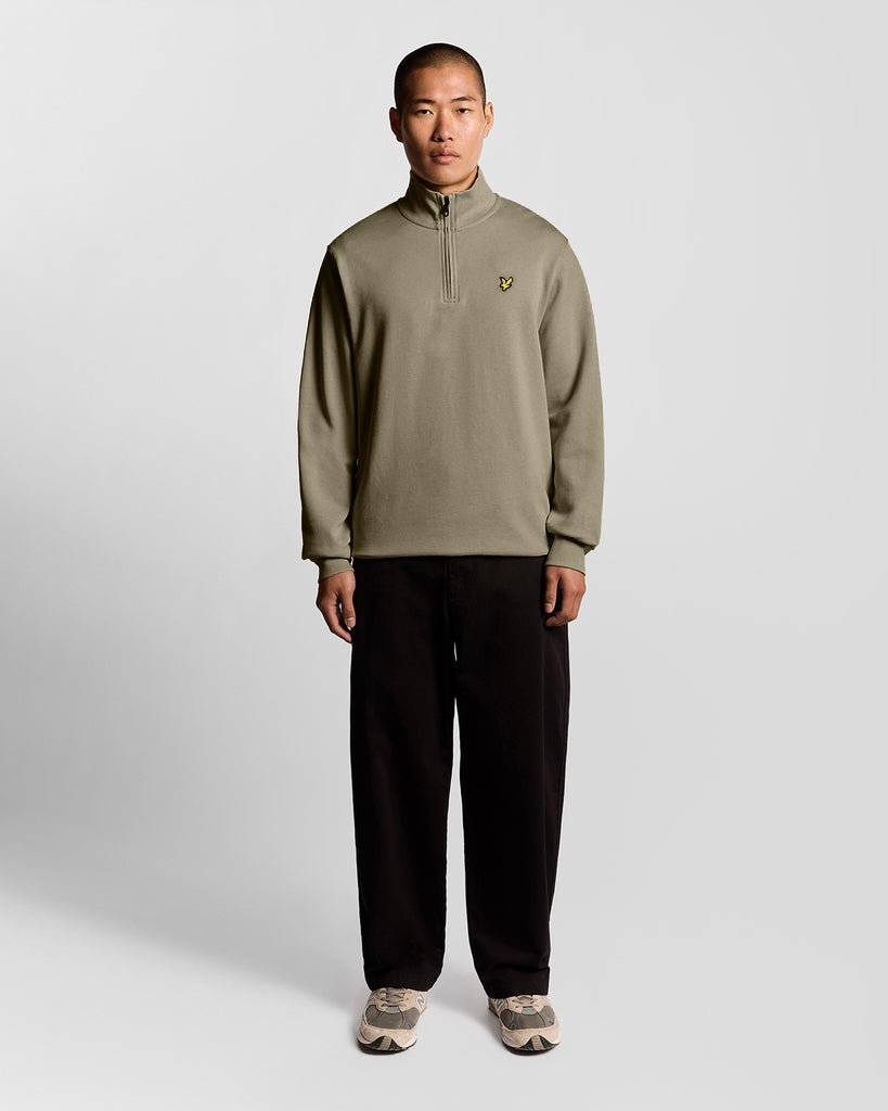 Man wears Everyday 1/4 Zip Cotton Sweatshirt in Woolwich