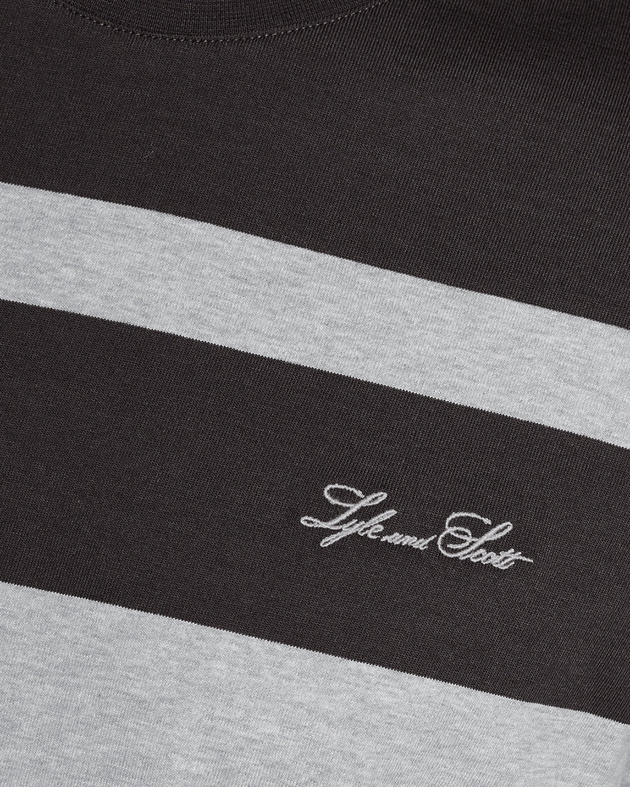 Man wears Relaxed Fit Stripe T-Shirt in Charcoal Grey/ Light Grey Marl