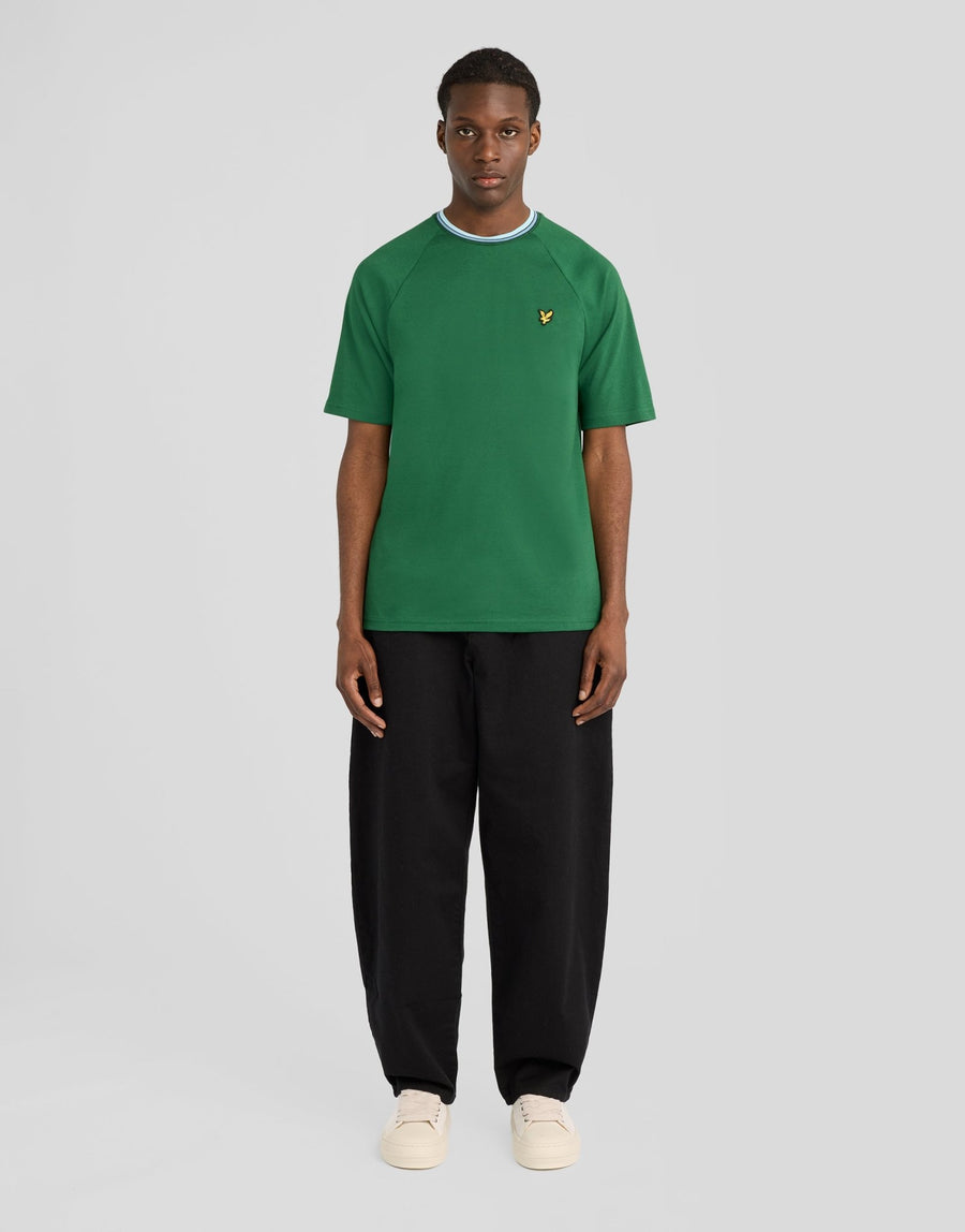 Man wears Tipped Track T-Shirt in Clover Green