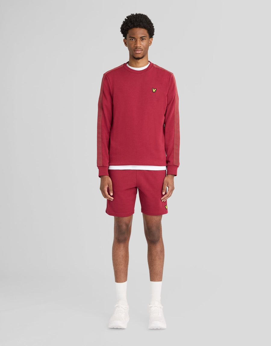 Man wears Sports Tape Crew Neck Sweatshirt in Plum