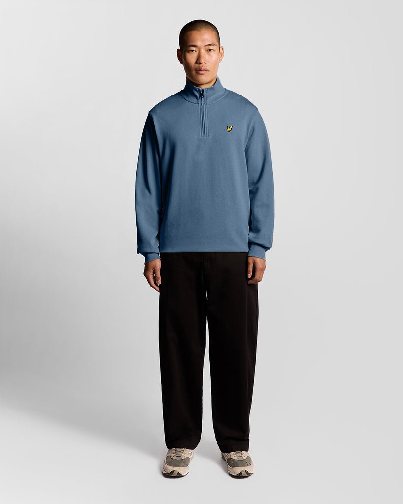Man wears Everyday 1/4 Zip Cotton Sweatshirt in Ocean Sky
