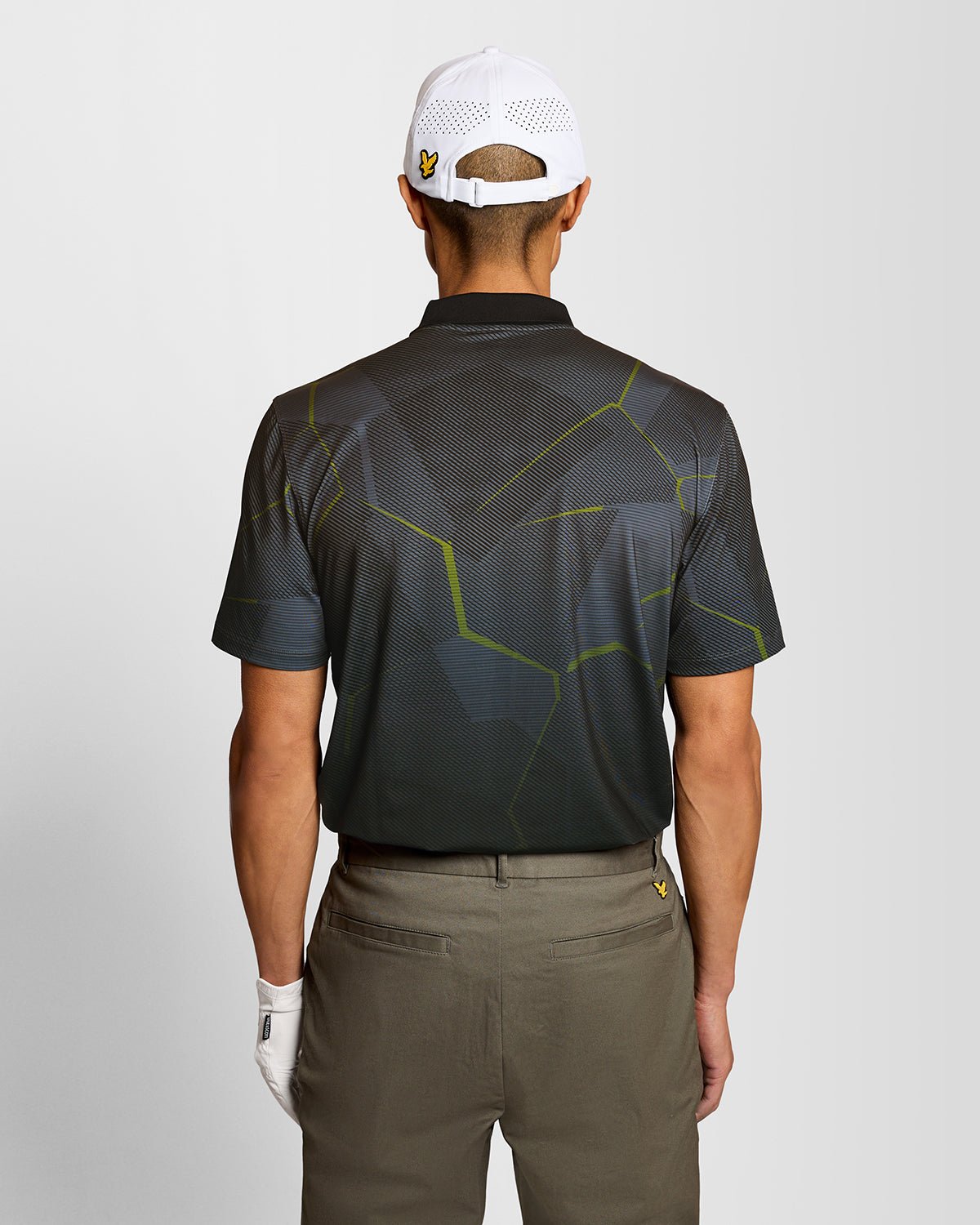 Un homme porte un polo à motif géométrique noir de jais