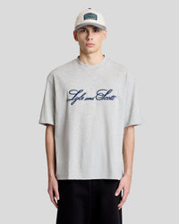 Man wears Script Logo Crew Neck T-Shirt in grey