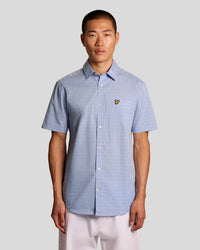 Man wears Short Sleeve Grid Check Shirt in Chalk Blue