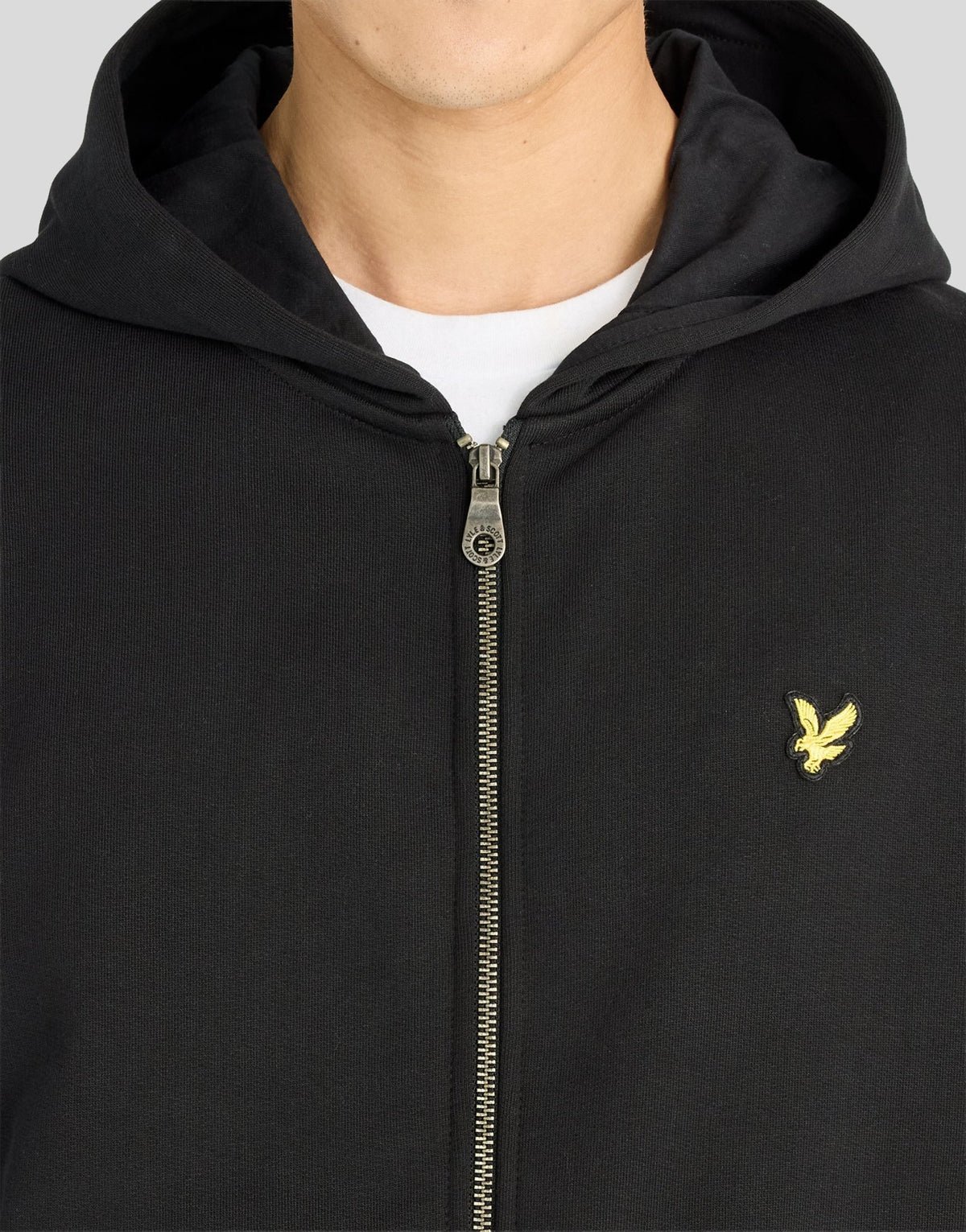 Man wears Heavyweight Loopback Zip Hoodie in Jet Black
