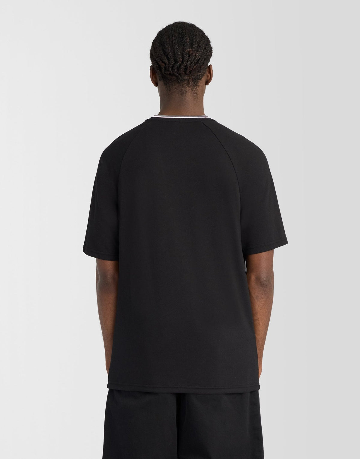 Man wears Tipped Track T-Shirt in Jet Black