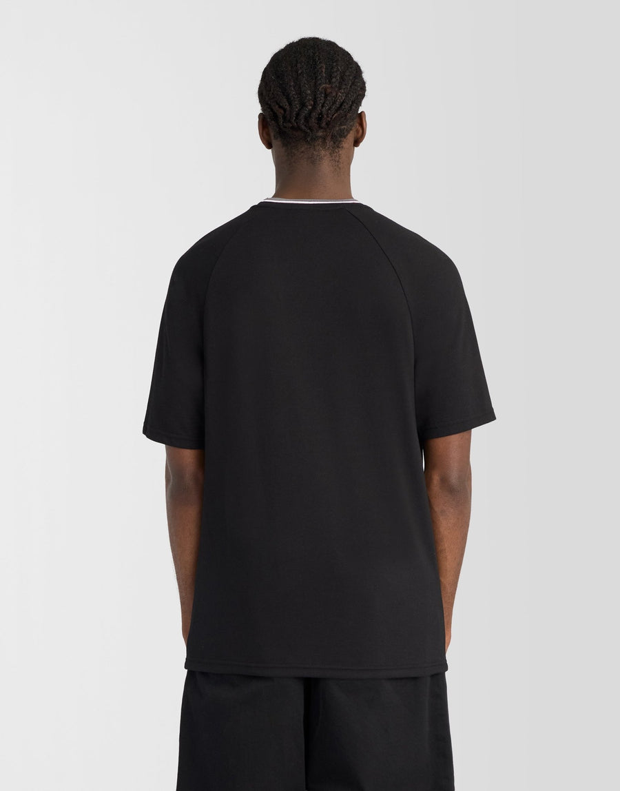 Man wears Tipped Track T-Shirt in Jet Black