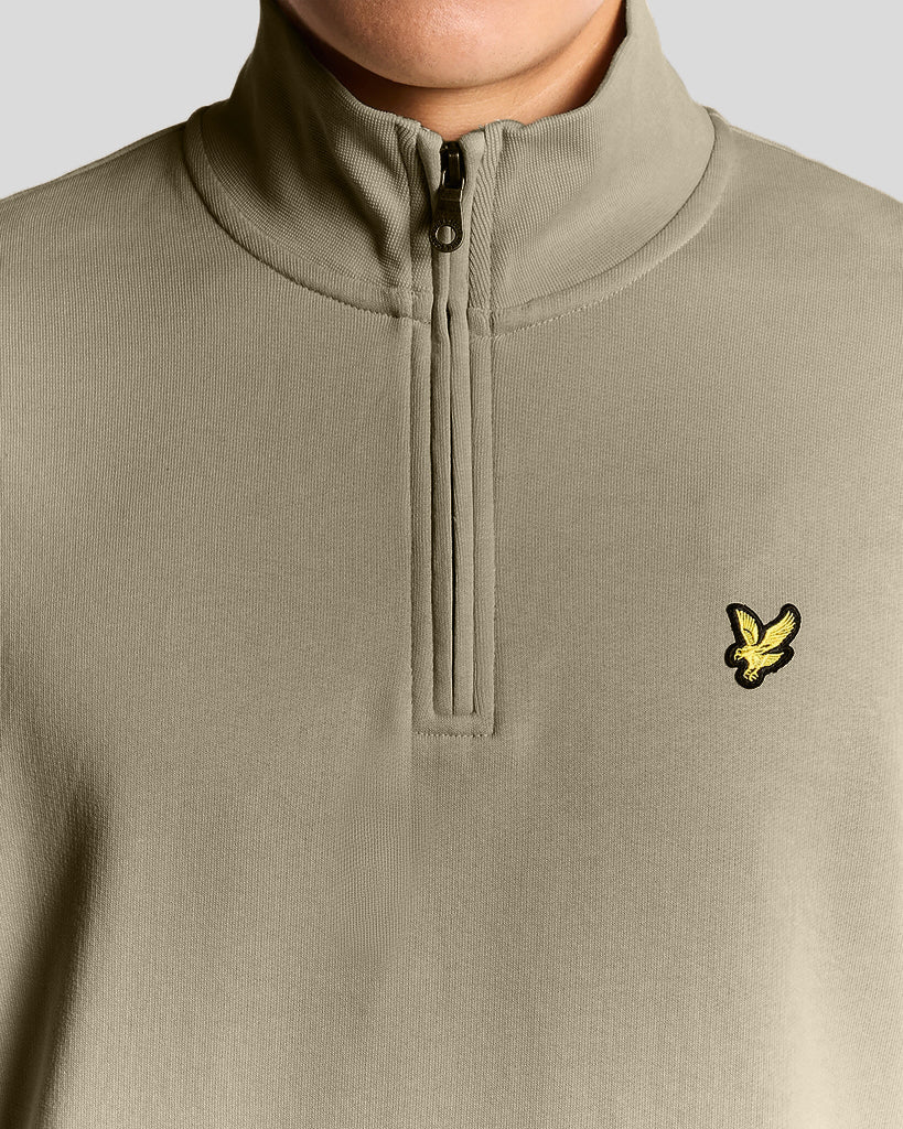 Man wears Everyday 1/4 Zip Cotton Sweatshirt in Woolwich