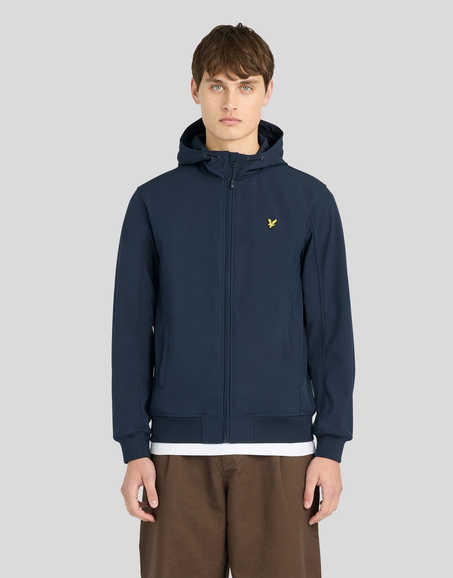 Man wears Sports Mesh-Back Softshell Jacket in Dark Navy