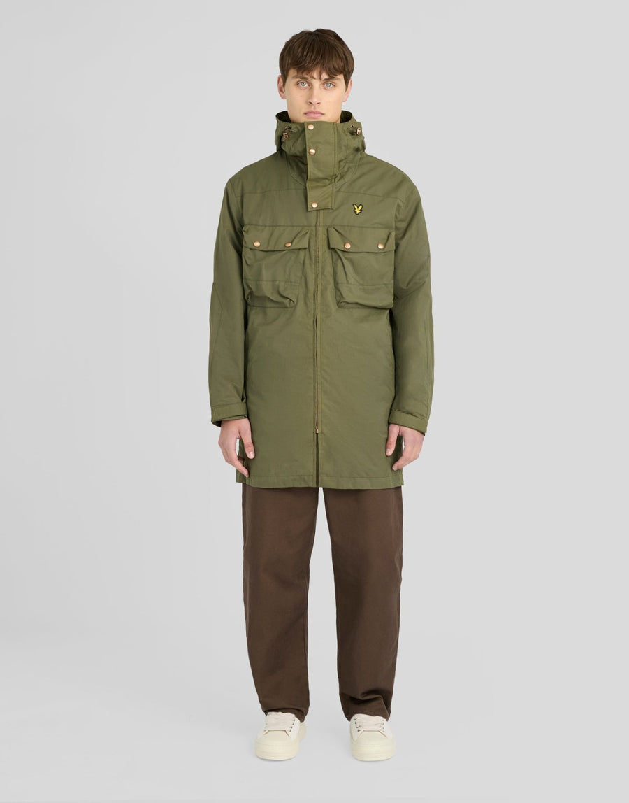Man wears Waxed Guard Parka in True Olive