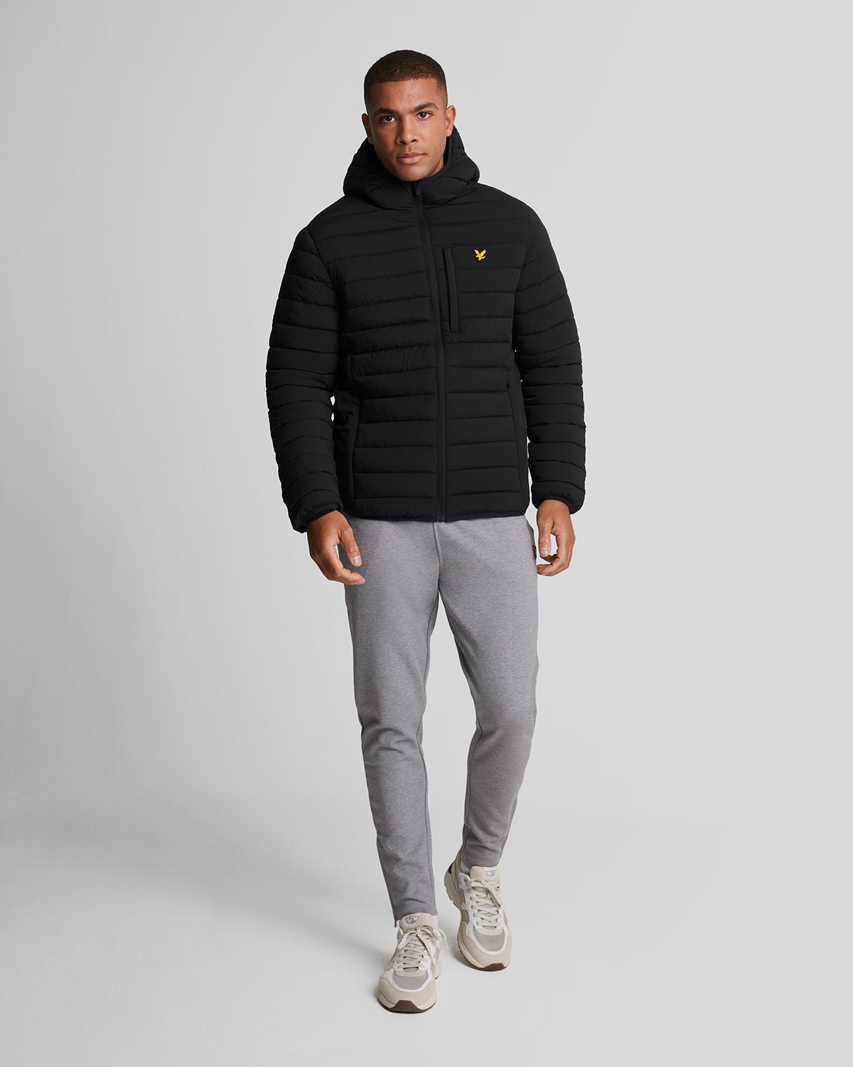 Man wears Sports Water Resistant Puffer Jacket in Jet Black